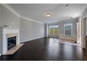 Bright living room featuring a fireplace, hardwood floors, and large windows providing plenty of natural light at 1016 Manchester Way # 43, Roswell, GA 30075