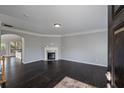 Cozy living room with dark hardwood floors, fireplace, and open floor plan to the kitchen at 1016 Manchester Way # 43, Roswell, GA 30075