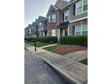 Street view of townhouses with well-kept lawns and uniform landscaping at 5449 Festival Ave, Fairburn, GA 30213