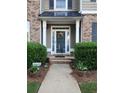 Inviting front entry with brick steps, potted plants, and decorative wreath at 5449 Festival Ave, Fairburn, GA 30213