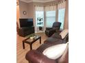 Spacious living area with comfortable seating, offering great natural light from bright windows at 5449 Festival Ave, Fairburn, GA 30213