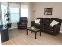 Cozy living room showcasing wood-look flooring and plenty of natural light at 5449 Festival Ave, Fairburn, GA 30213