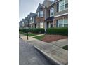 Well-maintained townhomes with tidy landscaping along a quiet street at 5449 Festival Ave, Fairburn, GA 30213