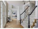 Entryway featuring hardwood floors, staircase, and a view into the office space at 125 Ketton Xing, Johns Creek, GA 30097