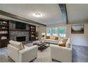 Inviting living room with a stone fireplace, built-in bookshelves, and ample seating at 3647 Miller St, Lithia Springs, GA 30122