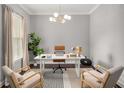 Bright office with a modern desk, chairs, and a large window with lots of natural light at 403 Aristides Way, Canton, GA 30115