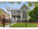 Beautiful two-story home featuring a well-manicured lawn, classic architecture, and a wrought iron fence at 907 Edgewood Ave, Atlanta, GA 30307