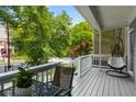 Cozy front porch with a hanging chair and table overlooking the neighborhood at 907 Edgewood Ave, Atlanta, GA 30307