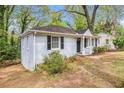 View of the front yard, landscaped garden bed, and house with black shutters at 2168 Doris Dr, Decatur, GA 30034