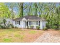 Well-maintained home featuring manicured lawn, black shutters, and a paved driveway at 2168 Doris Dr, Decatur, GA 30034