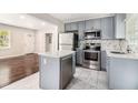 Modern kitchen with stainless steel appliances, gray cabinetry, and a kitchen island at 2168 Doris Dr, Decatur, GA 30034
