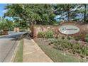 Beautiful stone entrance to the Ballantrae community with mature trees and landscaping at 2444 Ballantrae Cir, Cumming, GA 30041