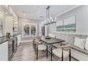 Inviting dining area with a comfortable built-in bench and modern chandelier at 2444 Ballantrae Cir, Cumming, GA 30041