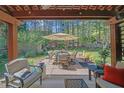Backyard with outdoor seating under a covered patio and views of the trees at 35 Kestrel Circle, Covington, GA 30014