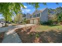 Beautiful home with a two-car garage, surrounded by lush greenery and landscaped lawn at 35 Kestrel Circle, Covington, GA 30014
