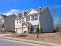 Charming two-story home with gray siding, brick accents and a well-manicured lawn at 5460 Wheeler Ridge Rd, Auburn, GA 30011