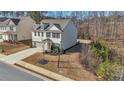 Charming two-story home with gray siding, brick accents and a well-manicured lawn at 5460 Wheeler Ridge Rd, Auburn, GA 30011
