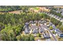 An aerial view shows a neighborhood's layout with tree-lined streets, cul-de-sacs, and proximity to nature, offering serene living at 116 Edgeview Ct, Dallas, GA 30157