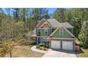 Charming two-story home featuring a two-car garage, stone accents, manicured landscaping and a walkway to the front door at 116 Edgeview Ct, Dallas, GA 30157