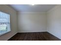 Bedroom with crown molding, wood-look floors and a large window with blinds at 3005 Stonebrook Cv, Austell, GA 30106