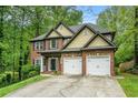 Charming two-story home with a brick facade, two-car garage, and well-manicured lawn and mature trees at 71 Anita Se Pl, Mableton, GA 30126