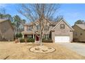 Beautiful two-story home with brick facade, well-kept lawn, and a welcoming front entrance at 1070 Cureton Dr, Austell, GA 30106