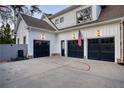 A spacious three-car garage with black doors and an American flag above it at 1226 Goodwin Ne Rd, Atlanta, GA 30324