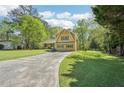 Charming two-story home with yellow siding, green shutters, and a well-manicured front lawn at 1522 Sprayberry Dr, Marietta, GA 30066