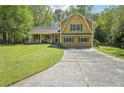 Charming two-story home with yellow siding, green shutters, and a well-manicured lawn at 1522 Sprayberry Dr, Marietta, GA 30066