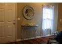 Entryway showcasing a decorative mirror, console table, and hardwood flooring at 20 Autumn Canyon Se Path, Cartersville, GA 30121