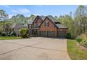 Brick two-story home with a three-car garage and very large driveway at 439 Lake Point Trce, Canton, GA 30114