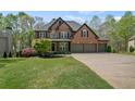 Inviting brick home with lush green lawn and manicured landscaping at 439 Lake Point Trce, Canton, GA 30114