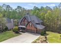 Stunning brick home with three-car garage, mature trees and lush landscaping at 439 Lake Point Trce, Canton, GA 30114