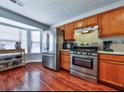 Well-lit kitchen featuring stainless steel appliances and hardwood flooring at 4420 Thorngate Ln, Acworth, GA 30101