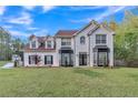 Charming two-story white brick home with manicured lawn and lovely landscaping at 3405 River Ridge, Stockbridge, GA 30281