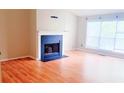 Spacious living room featuring a fireplace, large windows and laminate floors at 4443 Whitt Mill Nw Rd, Acworth, GA 30101