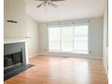 Spacious living room featuring a fireplace, large windows and laminate floors at 4443 Whitt Mill Nw Rd, Acworth, GA 30101