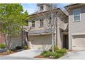 Attractive brick townhouse featuring a two-car garage, complemented by mature trees at 2251 W Village Se Ln, Smyrna, GA 30080