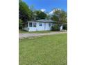 A quaint home displays an enclosed porch, side entry, and a spacious green yard at 3127 Bright Star Rd, Douglasville, GA 30135