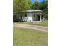 A white home featuring a covered porch and verdant surroundings at 3127 Bright Star Rd, Douglasville, GA 30135