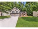 Charming two-story home with a two-car garage, stone accents and a well-manicured lawn at 3505 Oakshire Se Way, Atlanta, GA 30354
