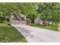 Charming two-story home with a two-car garage, stone accents and a well-manicured lawn at 3505 Oakshire Se Way, Atlanta, GA 30354