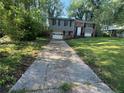 View of home with concrete driveway and lawn at 561 Santa Barbara Dr, Forest Park, GA 30297