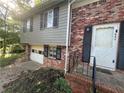 Close up of brick home featuring a front entrance and garage at 561 Santa Barbara Dr, Forest Park, GA 30297