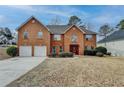 Charming two-story brick home with a well-manicured lawn and a two-car garage at 591 Paper Ridge Ct, Lawrenceville, GA 30046