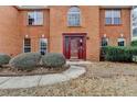 Close-up of the elegant red front door with sidelights and decorative trim at 591 Paper Ridge Ct, Lawrenceville, GA 30046