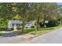 Beautiful exterior view of gray home featuring a lovely yard with a 'For Sale' sign at 2081 Verbena Nw St, Atlanta, GA 30314
