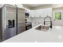 Bright, modern kitchen featuring stainless steel appliances, quartz countertops, and white cabinetry at 2081 Verbena Nw St, Atlanta, GA 30314