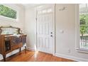 Bright entryway featuring a white door, classic trim, and a vintage wooden cabinet at 2124 Marshalls Se Ln, Atlanta, GA 30316