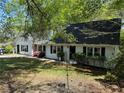 Beautiful home with lush greenery, updated windows and a charming entryway, creating a welcoming atmosphere at 3013 Barcelona Way, Conyers, GA 30012